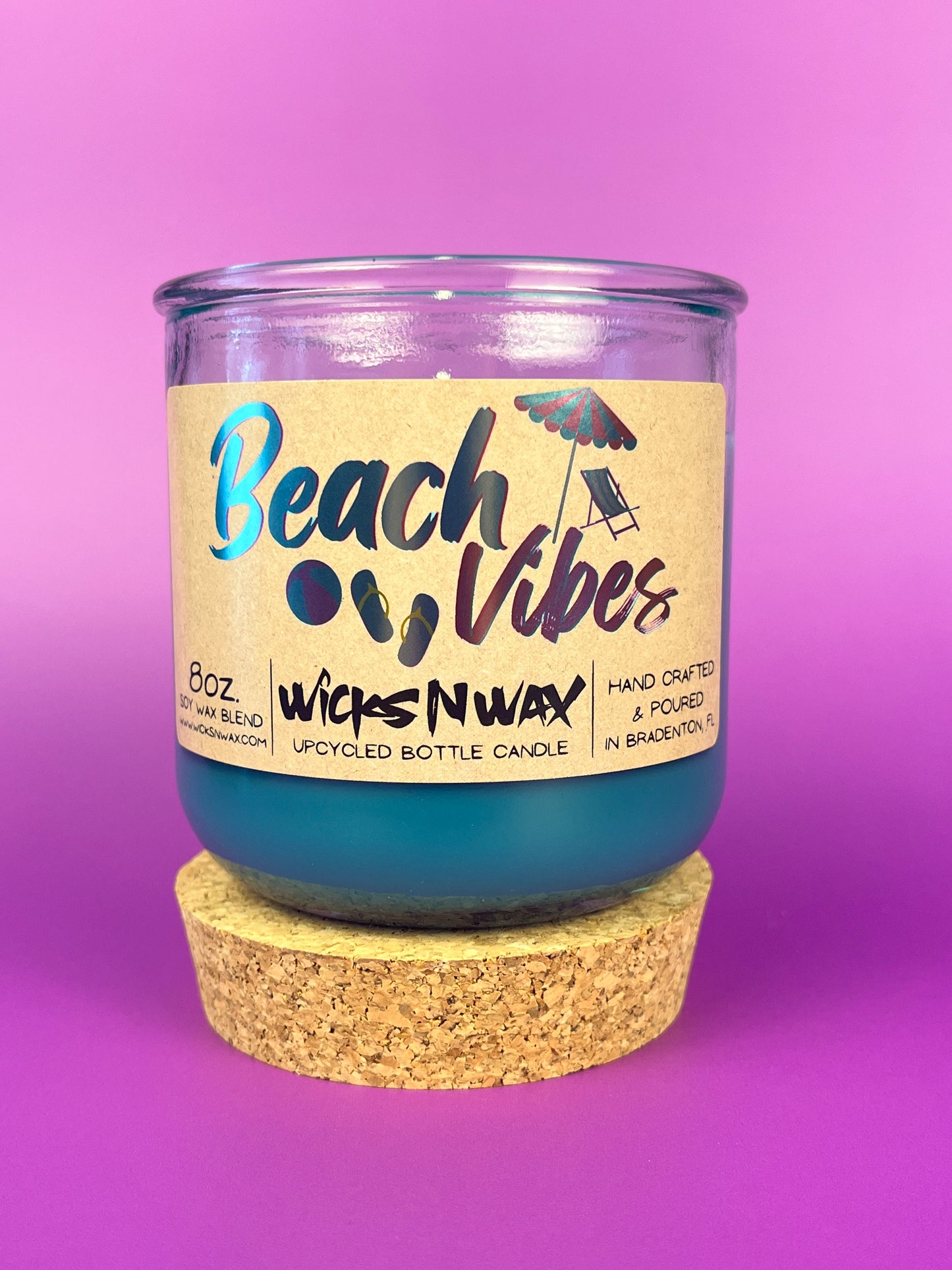 Recycled glass candle with blue wax, clear jar, cork base, beach-themed label