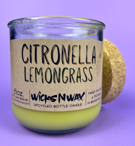 Recycled glass candle with green wax and “Citronella Lemongrass” label on front