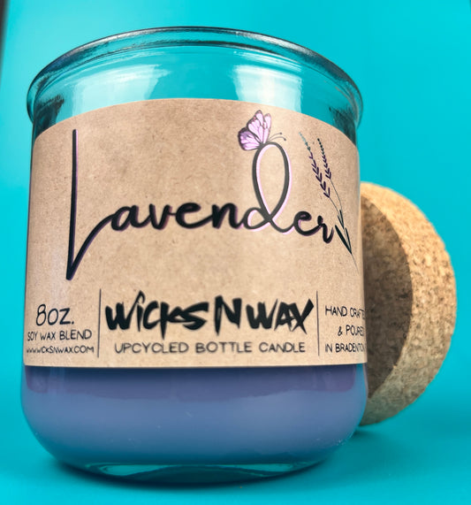 Lavender-scented candle in blue glass jar with cork coaster and lavender label
