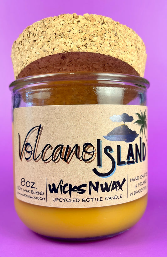 Recycled glass candle jar with Volcano Island label, yellow wax, cork base