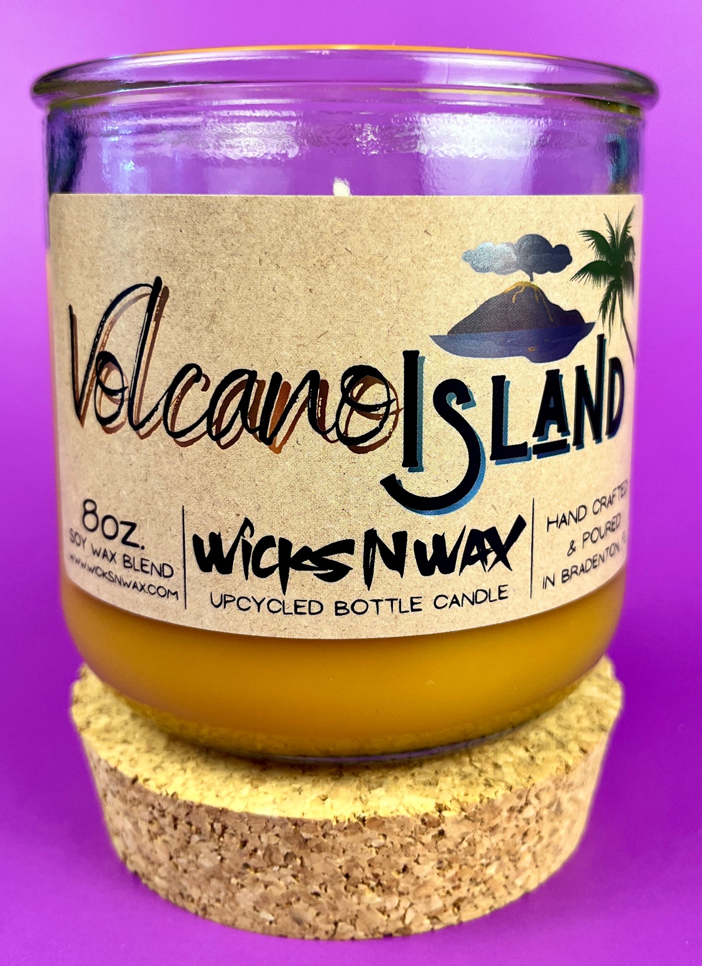 Recycled glass candle jar with Volcano Island label, yellow wax, cork base