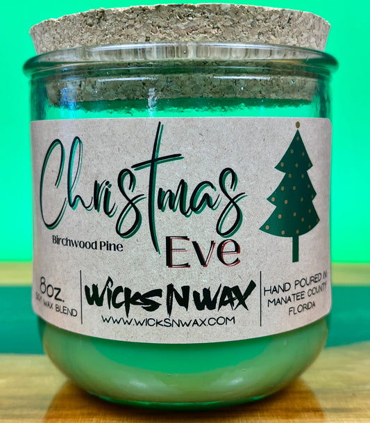 Christmas Eve recycled glass candle with cork lid and printed tree label.