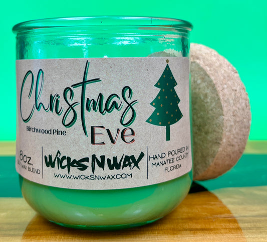 Christmas Eve recycled glass candle with cork lid beside the jar.