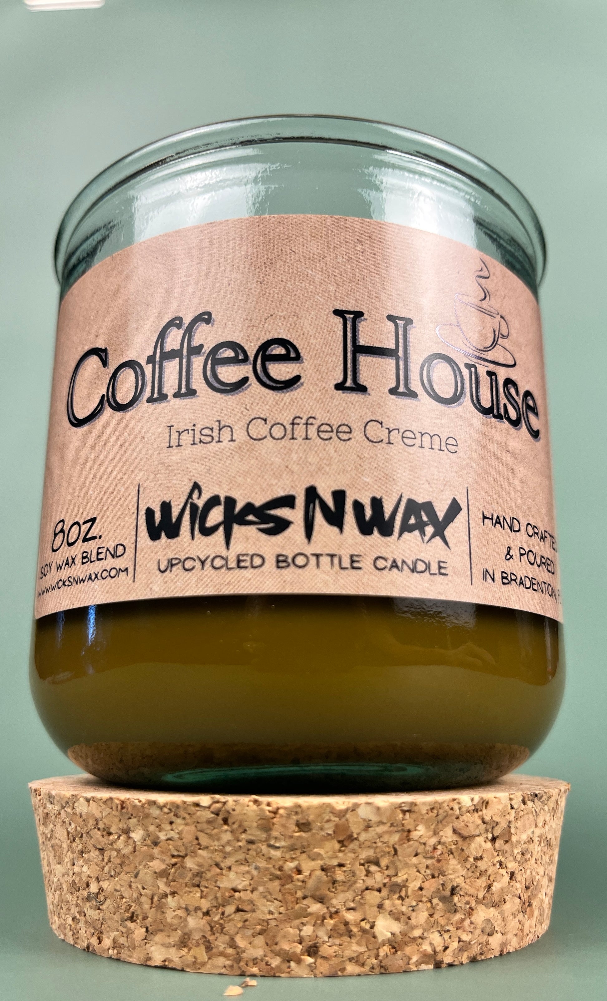 Recycled glass candle with cork base, amber wax, pink label reading Coffee House Irish Coffee Creme