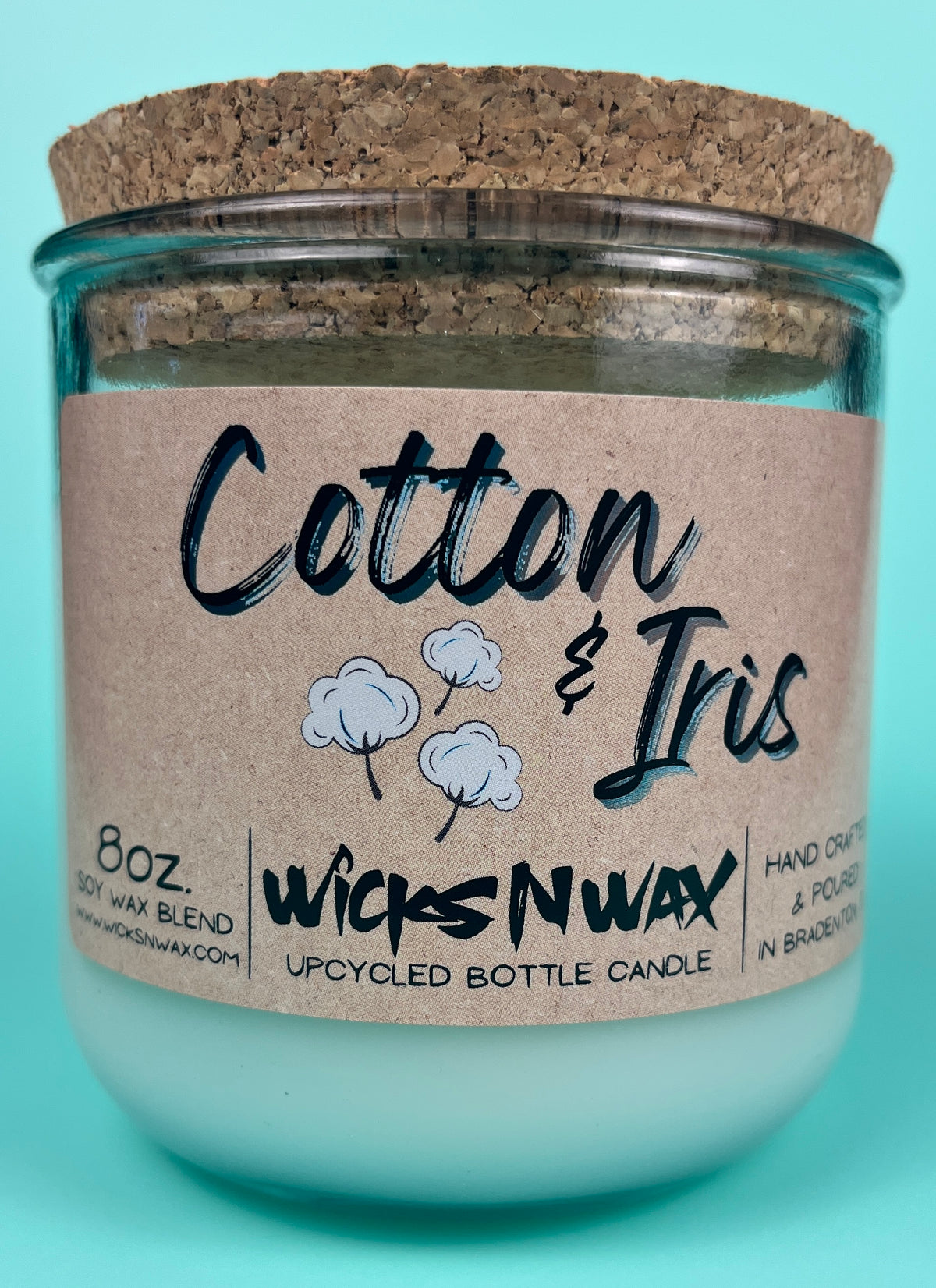 Recycled glass candle with cork lid and “Cotton & Iris” kraft label, front view