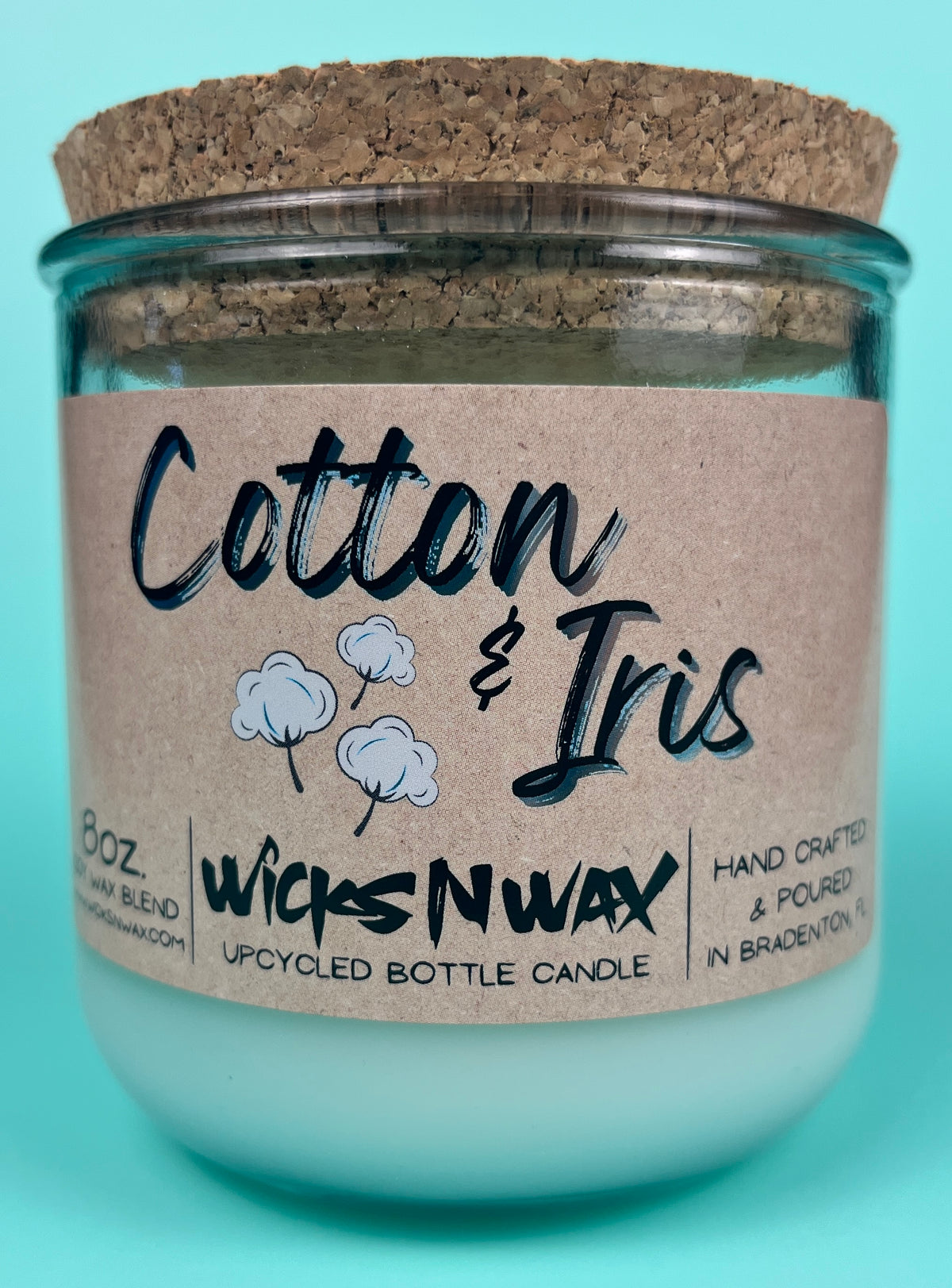 Recycled glass candle in clear jar with cork lid and kraft label, centered front