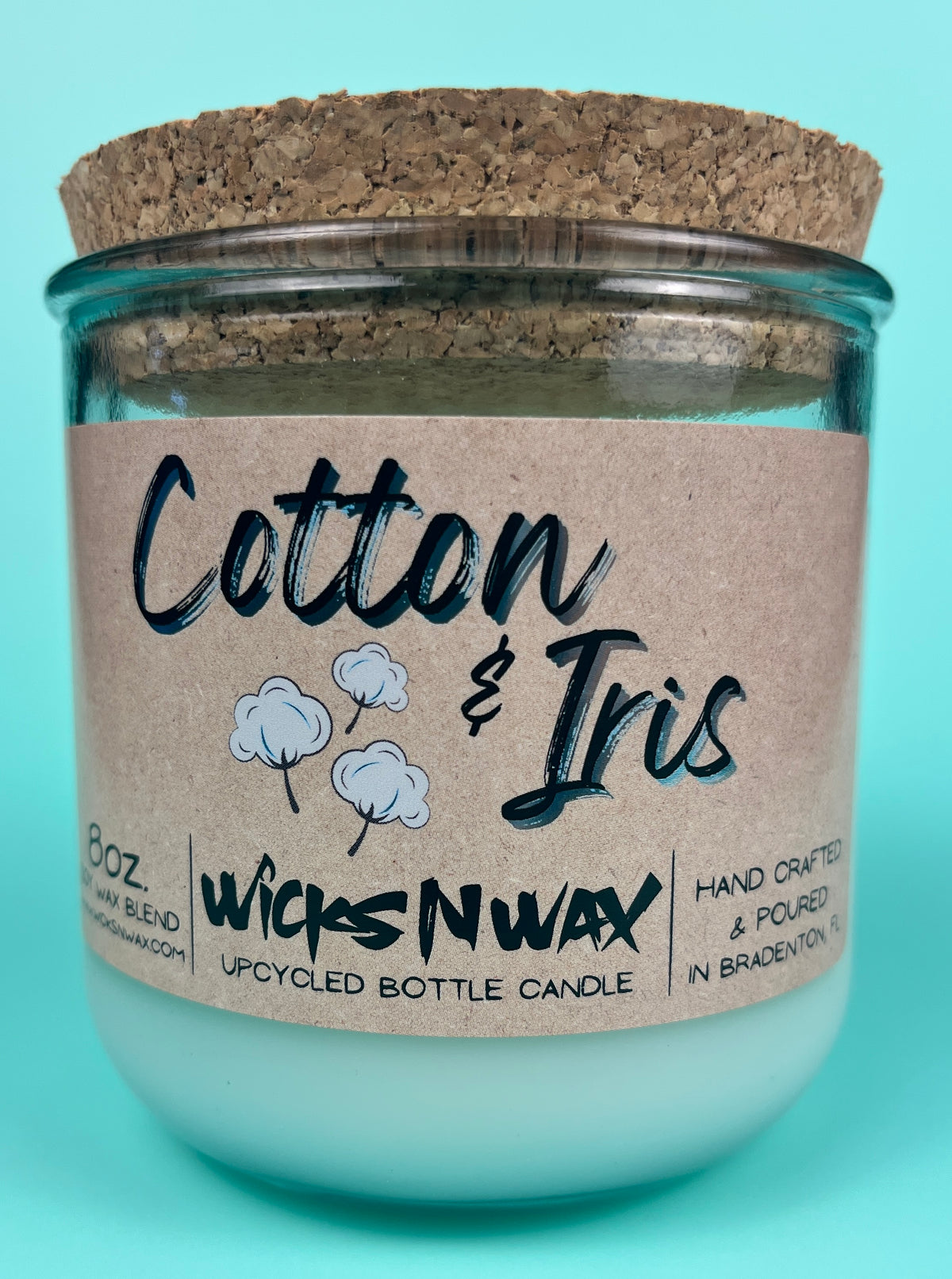 Recycled glass bottle candle with cork lid, Cotton & Iris label and WicksNWax logo