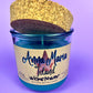Recycled glass candle with blue wax and beige label, cork lid partly covering top
