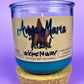 Recycled glass candle with blue wax, beige label, and cork lid plus cork coaster