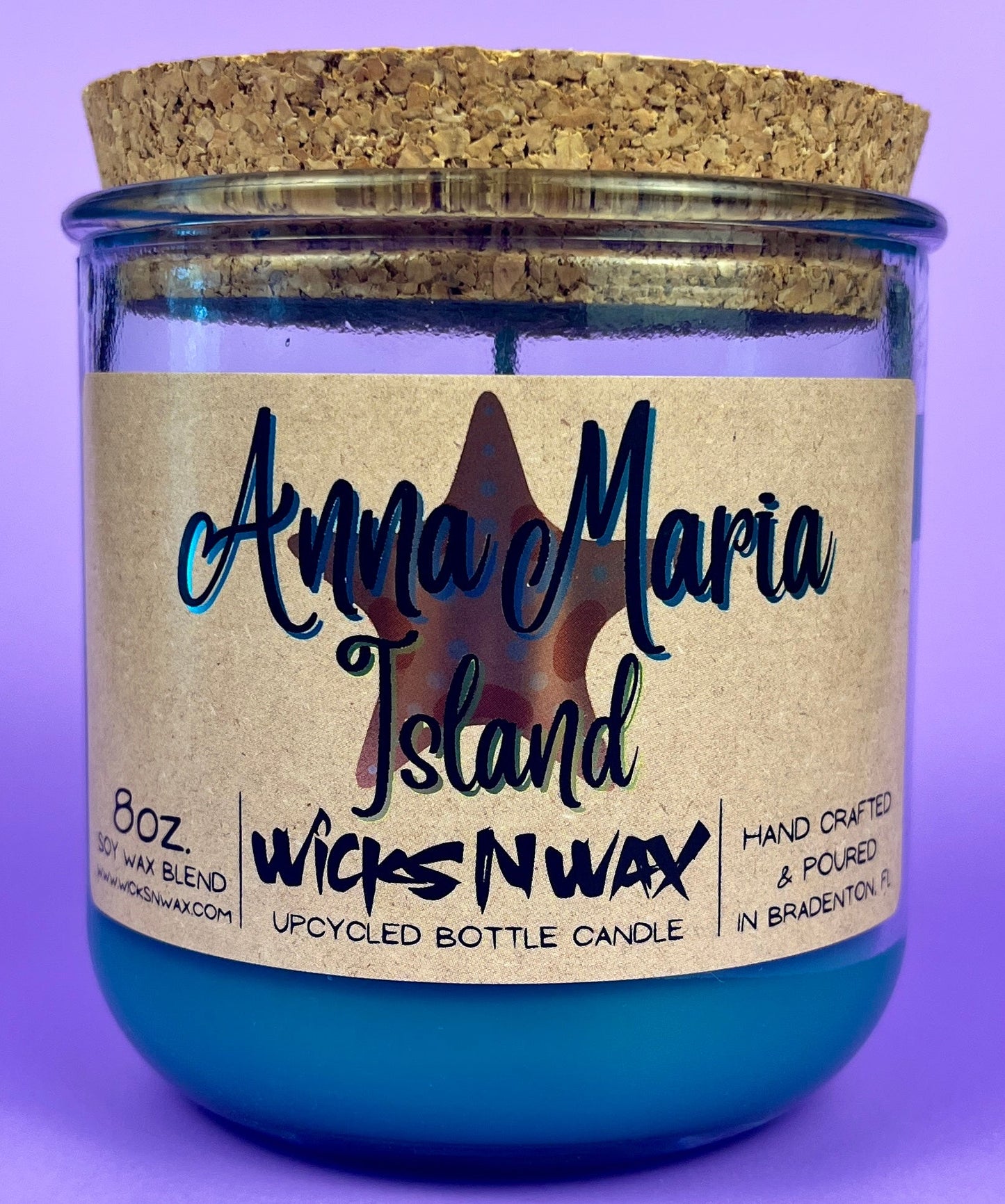Recycled glass candle in blue jar with cork lid and island label