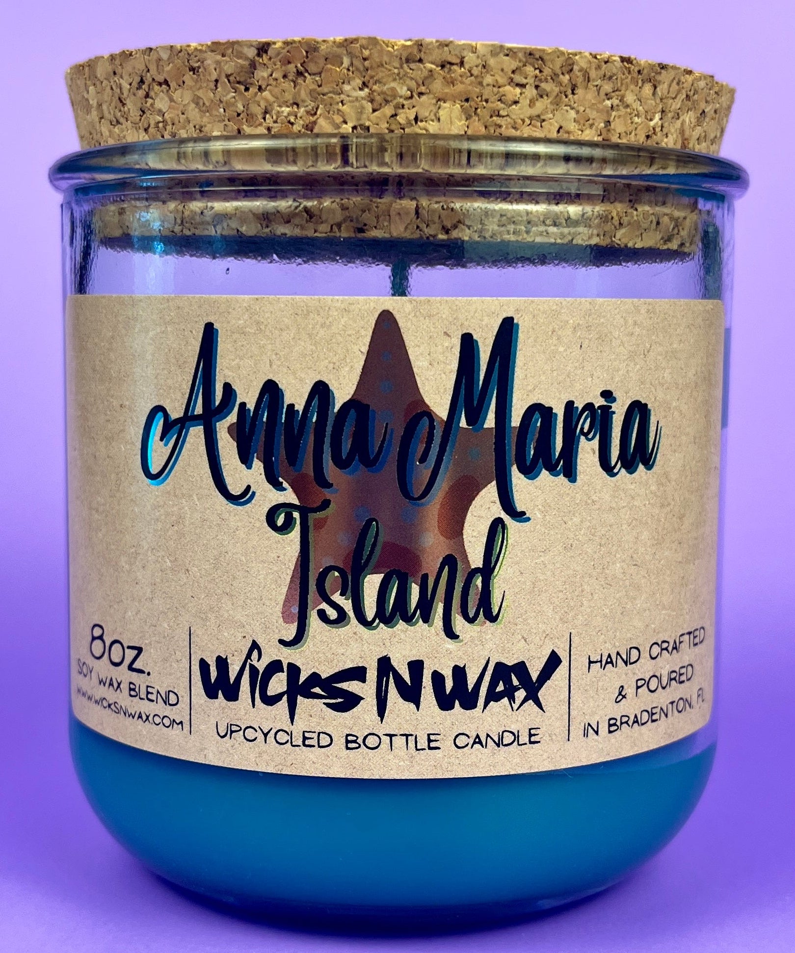 Recycled glass candle in blue jar with cork lid and island label