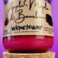 Recycled glass candle with red wax and Apple Maple & Bourbon label, cork base