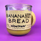 Recycled glass candle jar with Banana Nut Bread label and beige wax