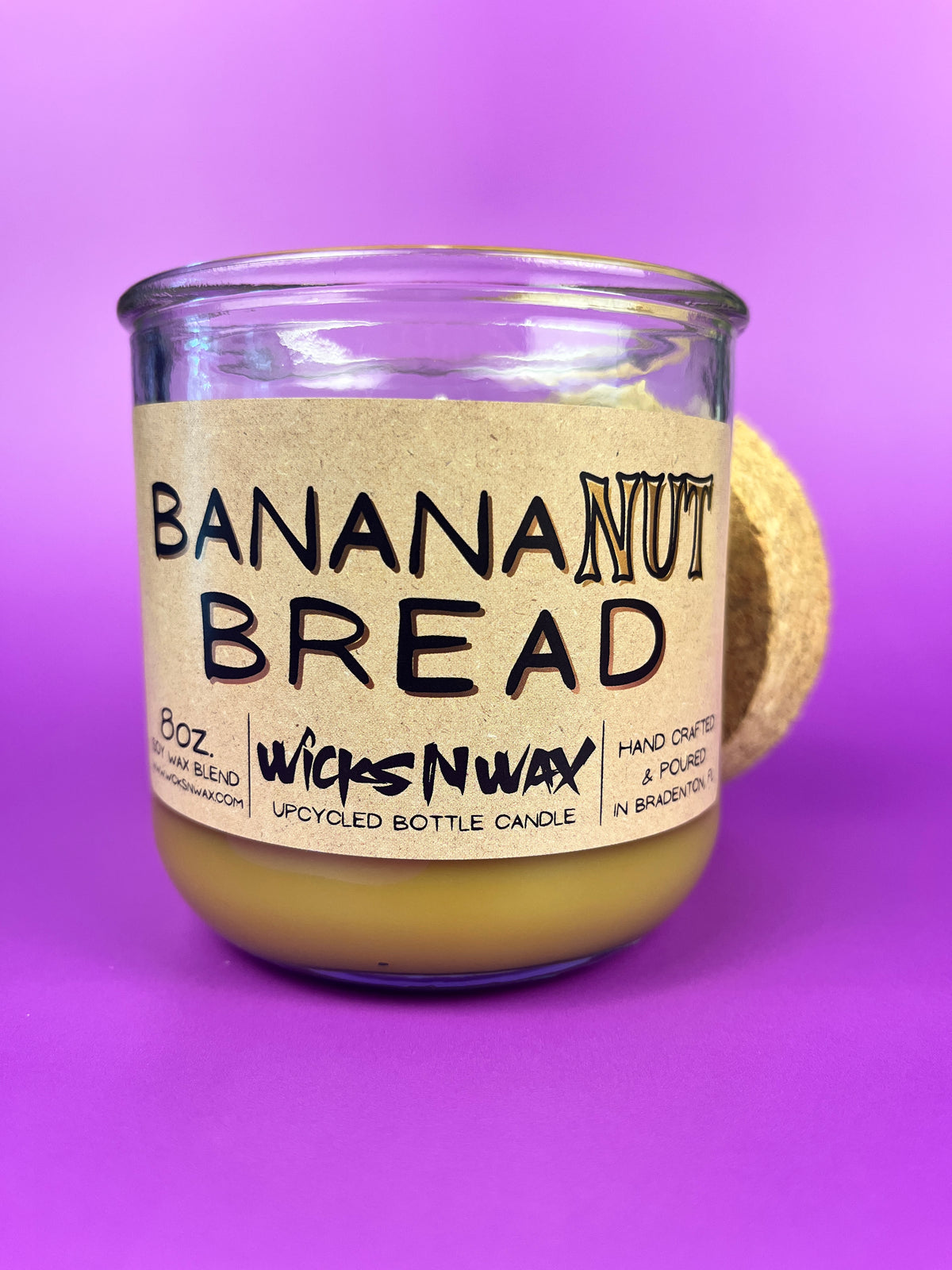 Recycled glass candle jar with Banana Nut Bread label and beige wax