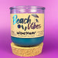 Recycled glass candle with blue wax, clear jar, cork base, beach-themed label