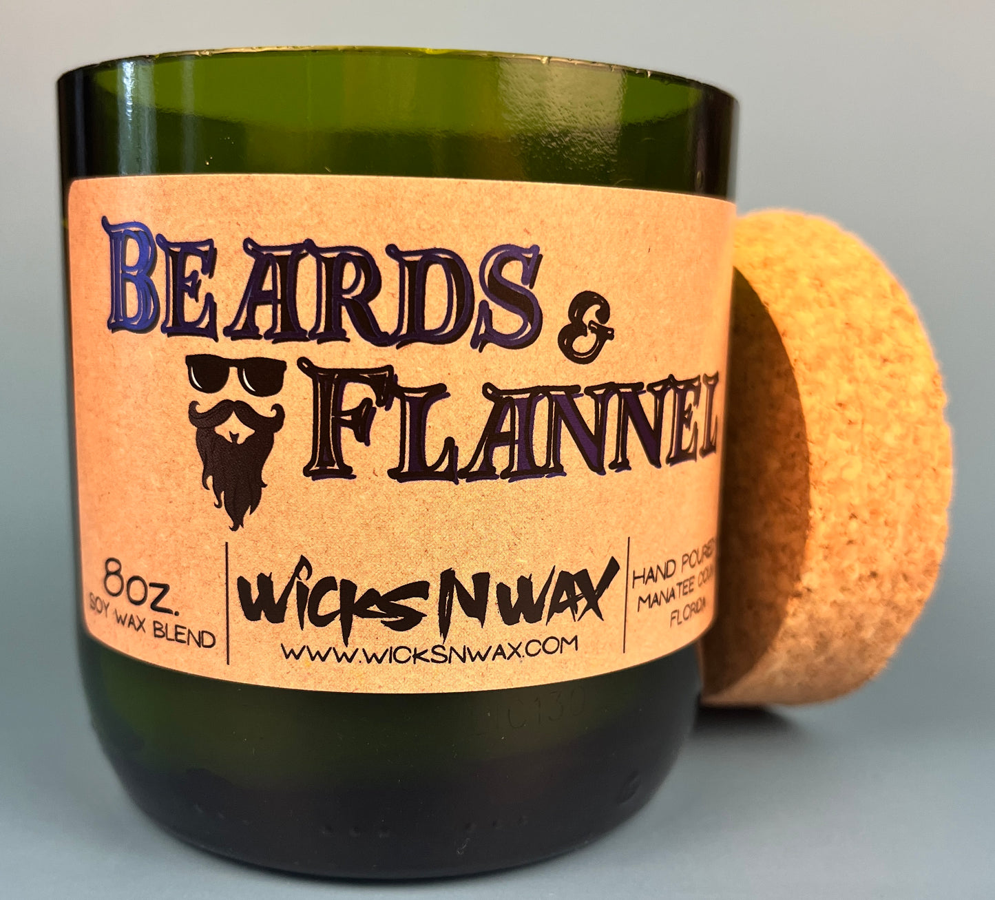 Dark green candle jar with cork lid and Beards & Flannel label