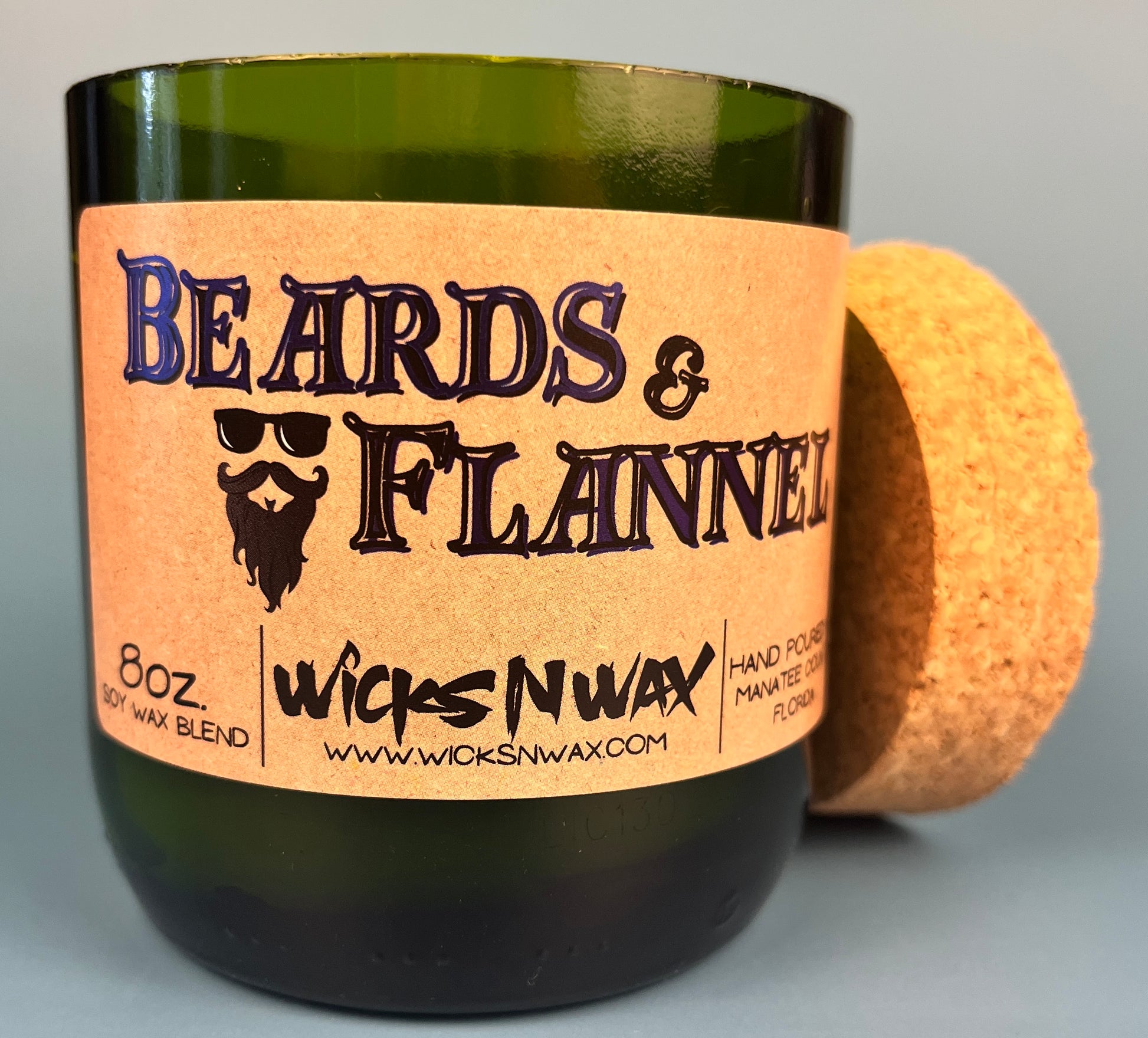Dark green candle jar with cork lid and Beards & Flannel label
