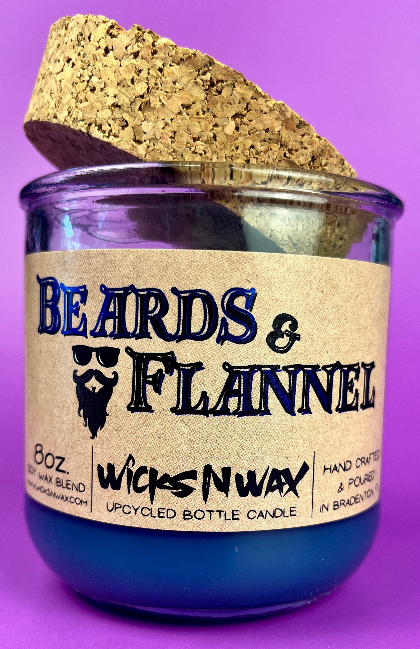 Blue recycled glass candle with cork lid and front label "Beards & Flannel".
