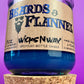 Blue recycled glass candle on cork coaster; label reads "Beards & Flannel".