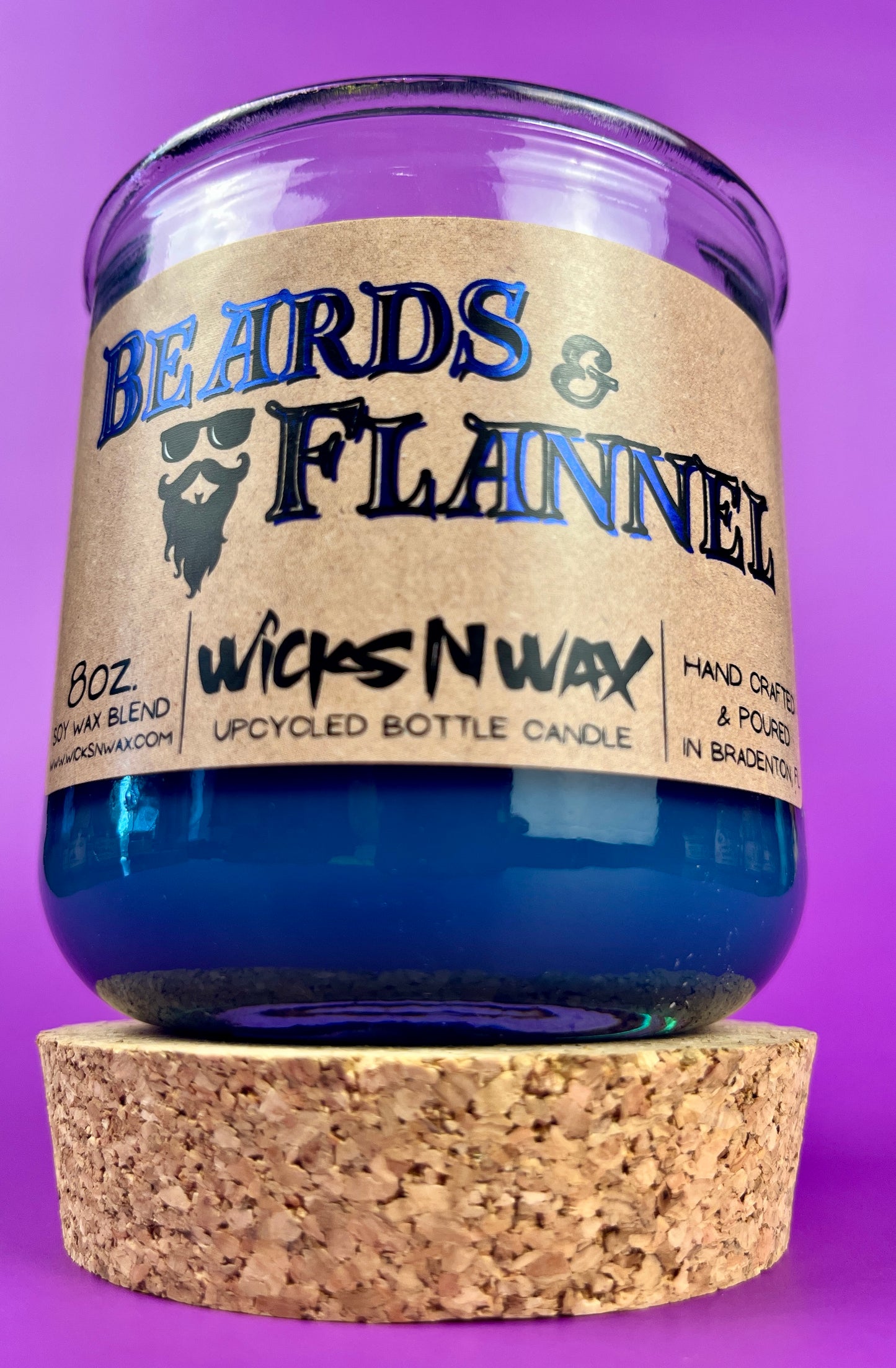 Blue recycled glass candle on cork coaster; label reads "Beards & Flannel".