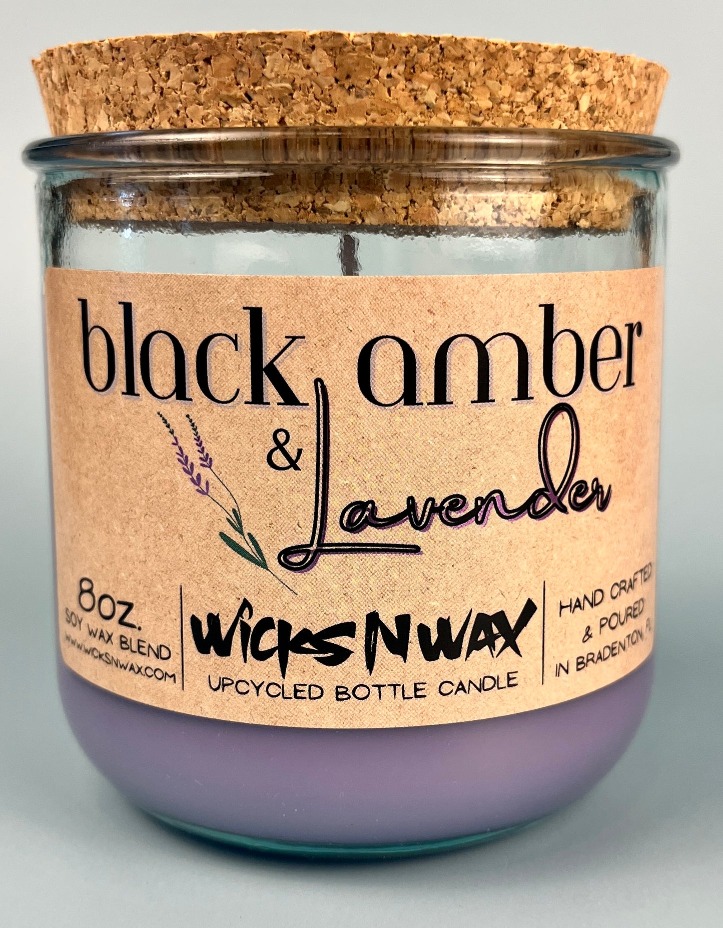 Recycled glass candle jar with cork lid and purple wax; WicksNWax Black Amber & Lavender label close