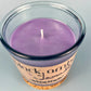 Recycled glass candle with visible white wick; purple wax inside jar