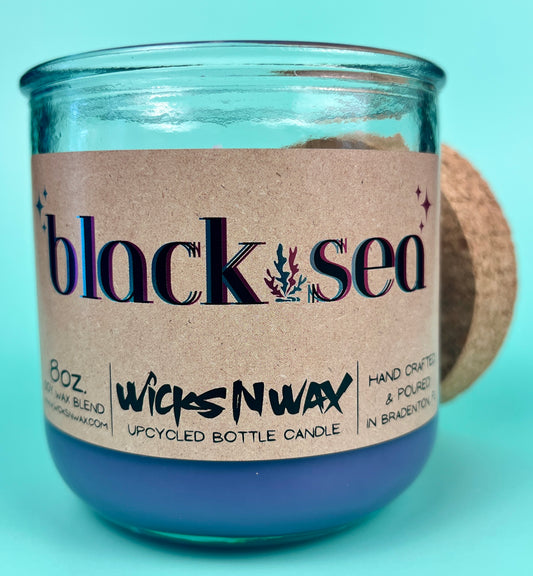Recycled glass jar candle with blue wax and kraft label on front