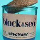 Recycled glass candle in blue jar with cork lid