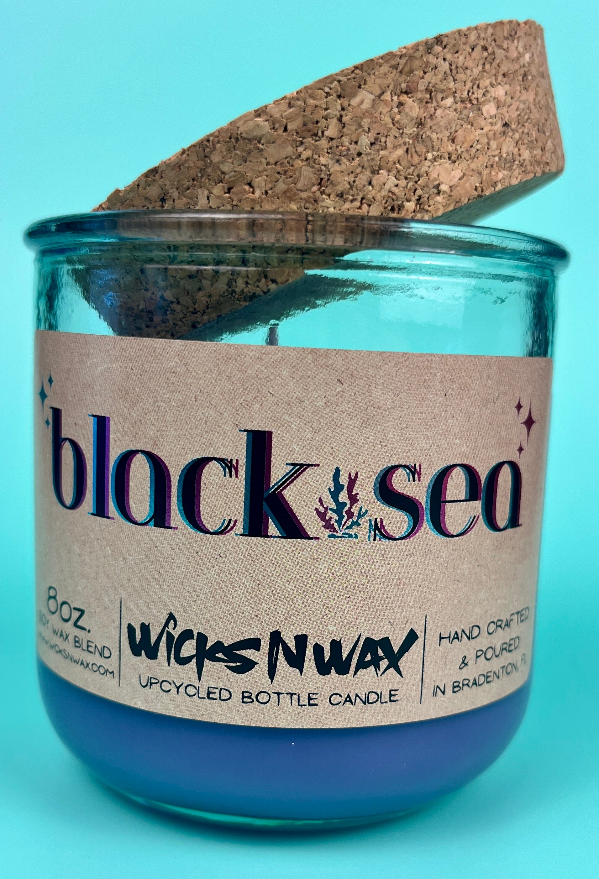 Recycled glass candle in blue jar with cork lid