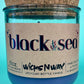Recycled glass candle in blue jar with cork lid, label and jar opening close-up