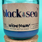 Recycled glass candle in blue jar; cork lid on bottom, label visible