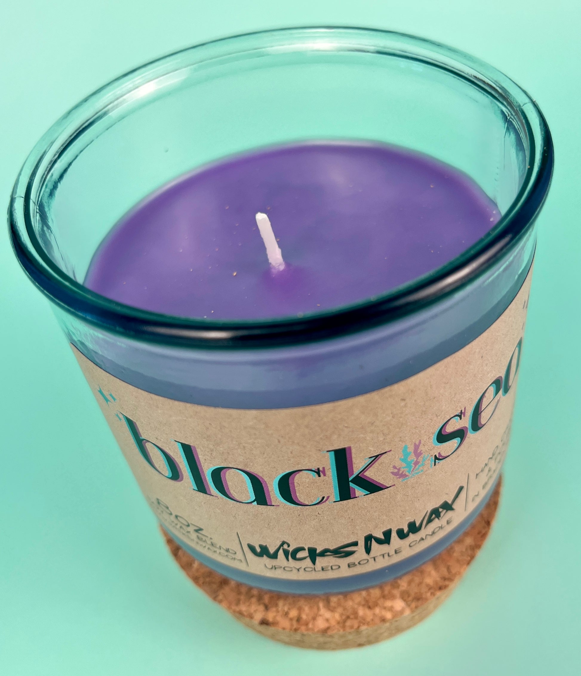 Recycled glass candle with cork band, blue glass jar with purple wax and wick