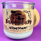 Recycled glass candle in clear jar with white wax and beige wrap label, showing artwork.