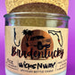Recycled glass candle in clear jar with white wax, beige label, and natural cork top.