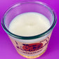 Recycled glass candle top view with white wax surface and central wick inside clear jar.