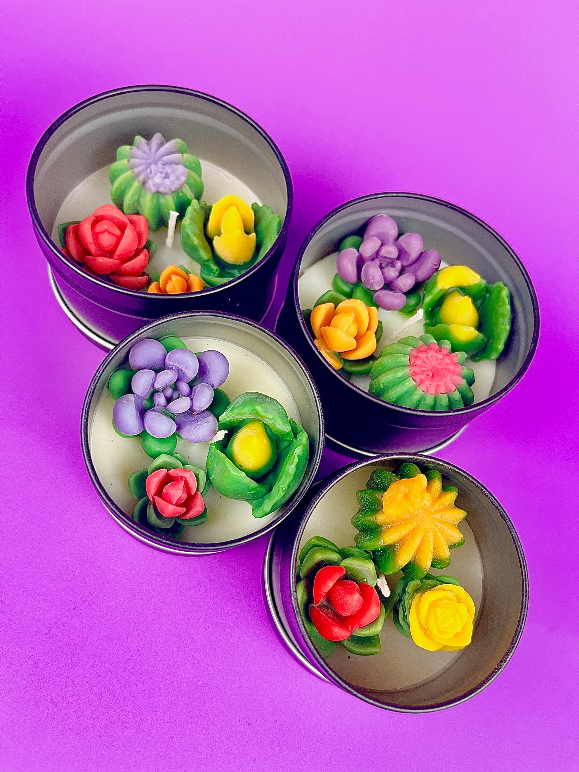 Small cactus art tin set with four cups showing pink, purple, yellow, and green wax