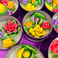 Small cactus art tin set with colorful flower-shaped wax pieces in silver cups