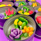 Small candle tin with green leaves, yellow and purple flowers, and pink rose