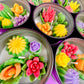 Large cactus art tin with colorful flower-shaped wax candles in round tins