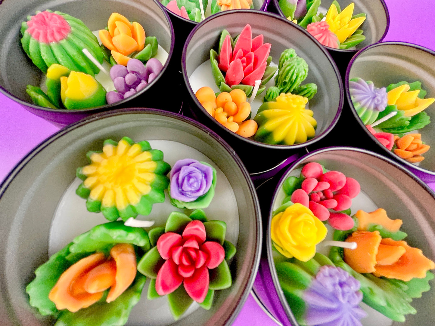 Large cactus art tin with colorful flower-shaped wax candles in round tins