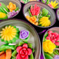 Large cactus art tin with flower-shaped wax pieces in green, yellow, purple, red and orange