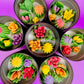 Large cactus art tin with assorted flower-shaped wax pieces in red, orange, yellow and purple