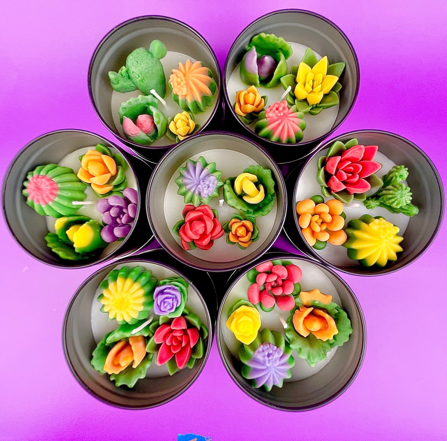 Large cactus art tin with colorful flower-shaped wax pieces arranged in circular compartments