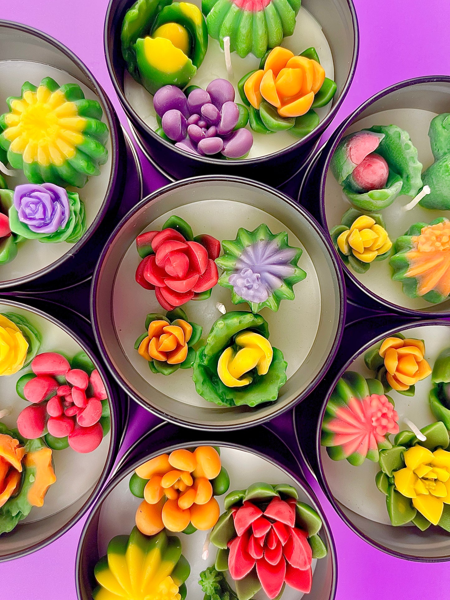 Large cactus art tin surrounded by flower-shaped wax pieces in yellow, red, orange and green