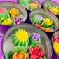 Large cactus art tin with green and purple roses plus orange and pink flower-shaped wax pieces