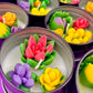Small cactus art tin set with central red rose wax and surrounding purple and green wax