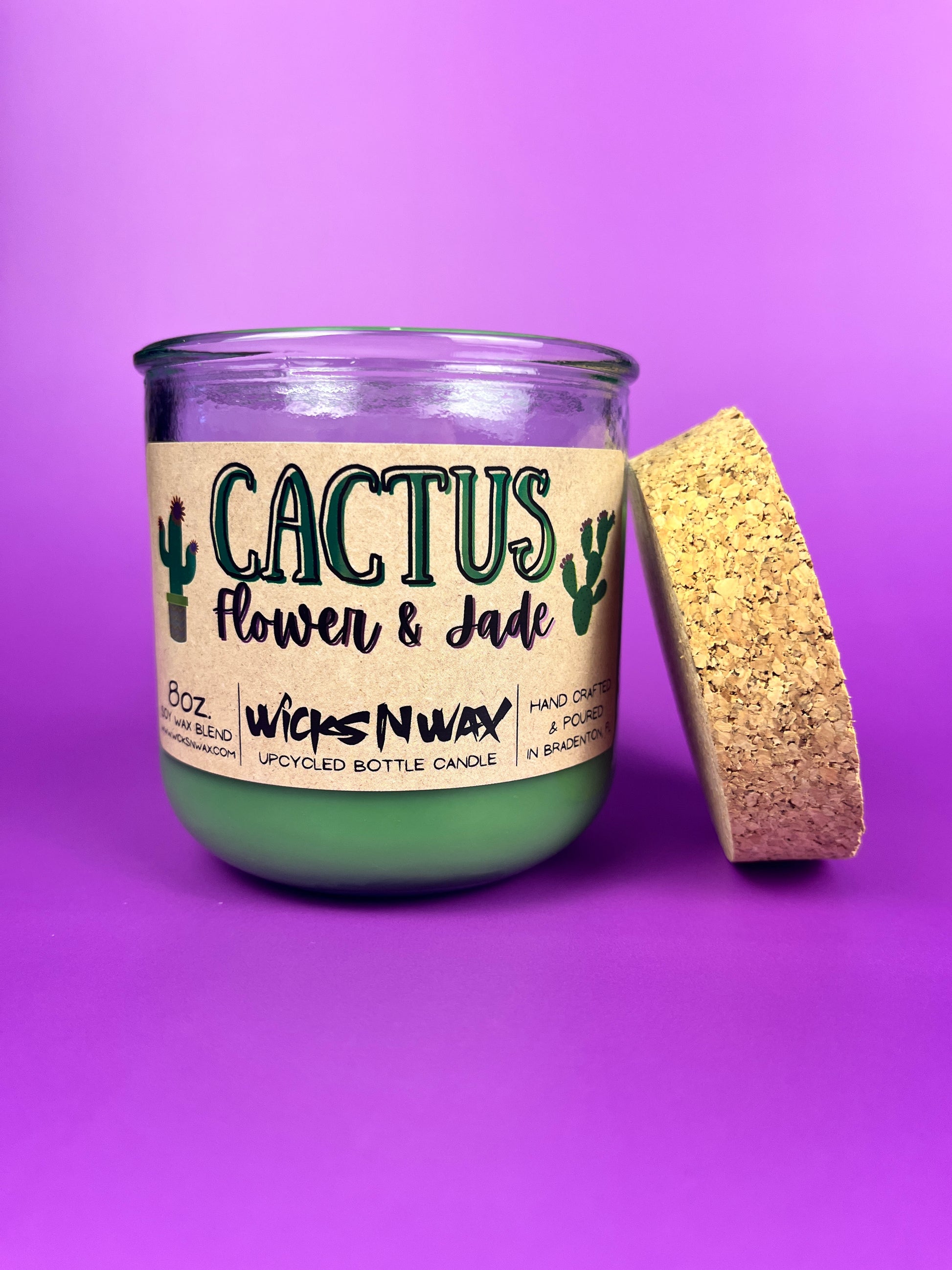 Recycled glass candle with cork lid on side; green jar and 'Cactus Flower & Jade' label.