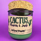 Recycled glass candle jar with printed label, green wax base, and tan cork top