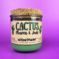 Recycled glass candle jar with printed label and green wax, tan cork lid on top