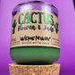 Recycled glass candle jar with green wax and tan cork base, label facing front